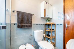 a small bathroom with a toilet and a shower at On the way!* in Portimão +45 photos