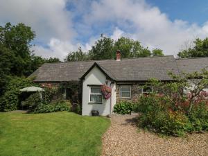 a house with a garden in front of it at Trawsnant Cottage in New Quay