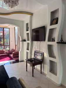 a living room with a tv on a wall at Mansoria,mohamedia in Pont Blondin