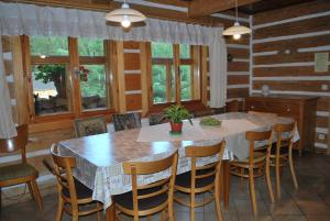 a dining room with a large table and chairs at Guest House U Marie in Pec pod Sněžkou