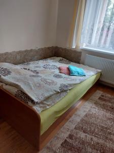 a bed with two pillows on it in a bedroom at Pokoje na Kamiennej in Gdynia +23 photos