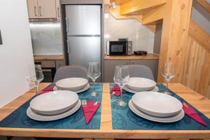 a table with plates and wine glasses on it at Filitsa's Luxury House in Chania Town