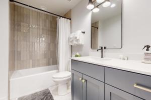 a bathroom with a sink and a toilet and a bath tub at Haverly Mountain Retreat in Crested Butte