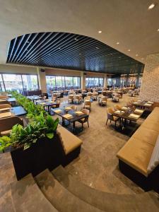 a restaurant with tables and chairs in a building at Grand Sapphire Casino 12 in Iskele