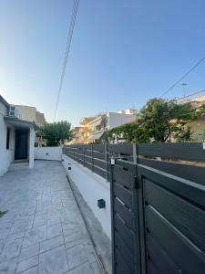 a fence on the side of a house at Sofia's House in Nea Moudania