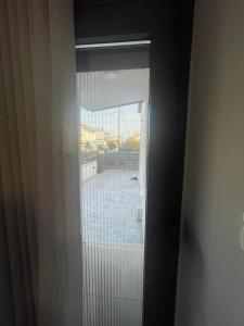 a glass door with a view of a courtyard at Sofia's House in Nea Moudania