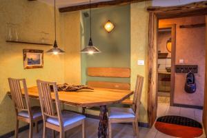a dining room with a wooden table and chairs at Apartment Kamacir in Kobarid