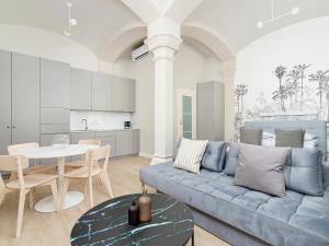 a living room with a blue couch and a table at Apartment - Main Square in Kraków