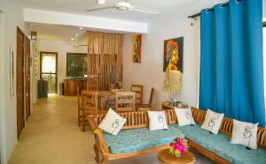 a living room with a couch and a table at Maracuja villa Zanzibar in Bwejuu