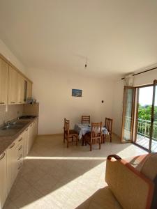a kitchen with a table and chairs and a dining room at Villa Pams in Baks-Rrjoll