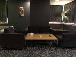 a waiting room with couches and a coffee table at Best Inn Erbil in Erbil