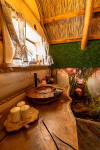 a bathroom with a wooden sink in a room at Pod Kogutem i Sową - Bio Wioska z domkami Premium w góralskim stylu dla dorosłych in Postołowo