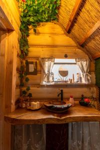 a small bathroom with a sink in a house at Pod Kogutem i Sową - Bio Wioska z domkami Premium w góralskim stylu dla dorosłych in Postołowo +54 photos