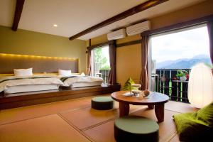Ένα ή περισσότερα κρεβάτια σε δωμάτιο στο Hotel Hakuba Berghaus +46 φωτογραφίες