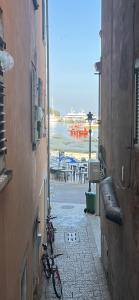 a bike parked on a street next to a beach at Apartman Passagio in Rovinj