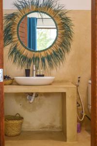 a bathroom with a sink and a mirror on a counter at Maracuja villa Zanzibar in Bwejuu