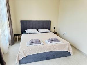 a bedroom with a bed with two pillows on it at Boho and More in Sozopol