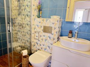 a bathroom with a toilet and a sink at Boho and More in Sozopol +19 photos