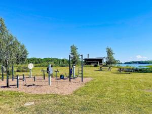 a playground in a field with a park with at 7 person holiday home in Rockneby-By Traum in Rockneby