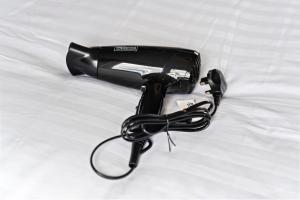 a hair dryer sitting on top of a bed at Leeds City Centre Serviced Accommodation in Hunslet