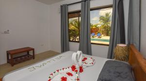 a bedroom with a bed with a view of the ocean at Maracuja villa Zanzibar in Bwejuu
