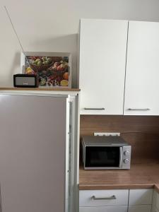 a kitchen with a microwave and a box of fruit at Apartment Van Eß Hof - Altstadt Warburg in Warburg