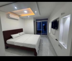 Postel nebo postele na pokoji v ubytování Hostal Las Orquideas 2