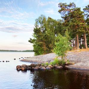a rock island in the middle of a body of water at Farm Stay B & B in Annerstad
