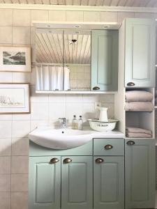 a bathroom with a sink and a mirror at Farm Stay B & B in Annerstad