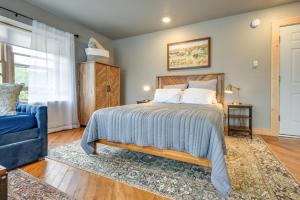 a bedroom with a bed and a blue chair at Meredith Studio Near Downtown Hike, Swim, Ski! in Meredith