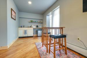 a living room with a chair and a kitchen at Meredith Studio Near Downtown Hike, Swim, Ski! in Meredith