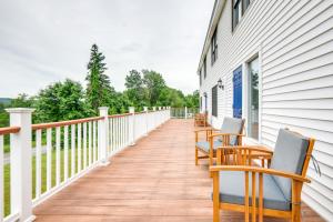 a porch with rocking chairs on a white house at Meredith Studio Near Downtown Hike, Swim, Ski! in Meredith