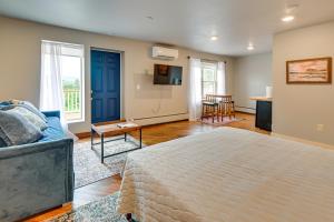 a room with a bed and a couch and a table at Cozy Meredith Studio Near Lakes and Downtown in Meredith