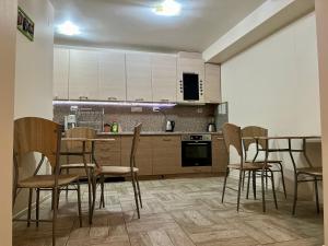 a kitchen with a table and chairs in a room at Хостел Атлас - Hostel Atlas in Blagoevgrad