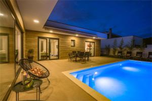 a swimming pool in the backyard of a house at Villa Aura in Pula