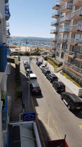 a row of cars parked in a parking lot next to a building at Charmant studio en bord de mer in Pornichet