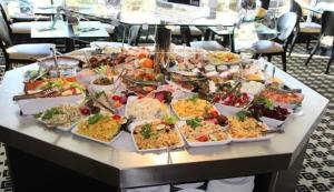 a buffet of food on a table in a restaurant at Charmant studio en bord de mer in Pornichet