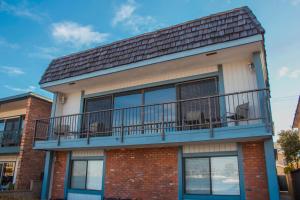 a building with a balcony with chairs on it at 925 W Bay Ave in Newport Beach
