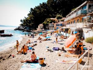 a group of people laying on a beach at Studio avec balcon - Plage à 10min à pied in Le Pradet +5 photos