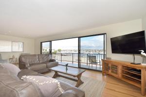 a living room with a large flat screen tv at 925 W Bay Ave in Newport Beach +79 photos