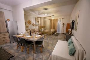 a kitchen and living room with a table and a couch at Irida in Kalymnos