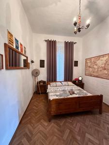 a bedroom with a bed and a chandelier at Old House in Cetinje