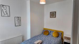 a bedroom with a bed and three pictures on the wall at 2 bedroom house perfect for contractors in Birmingham