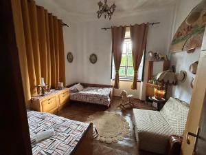 a bedroom with two beds and a window at Old House in Cetinje