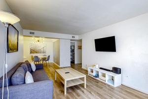 a living room with a couch and a tv at Desert Sky in Tempe