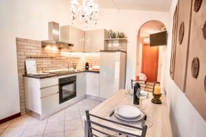 a kitchen with a wooden table and a dining room at La Casetta con giardino privato vicino Cascata delle Marmore in Terni