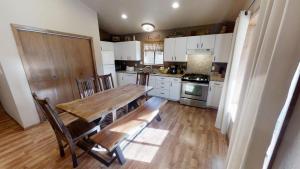 una cucina con tavolo in legno e pavimento in legno di Riverside Cabin - Pet Friendly - On the River - Hot Tub - WiFi - Washer - Dryer - Grill a Red River Altre 15 foto