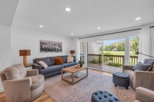 a living room with a couch and a table at Modern 3BR in Serene Area Near Ski Slopes and Town in Park City