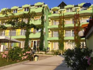 a green building with plants growing on it at Guesthouse Kamelia in Ahtopol