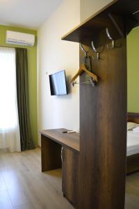 a hotel room with a desk and a bed at Hotel Tabernei in Tbilisi City